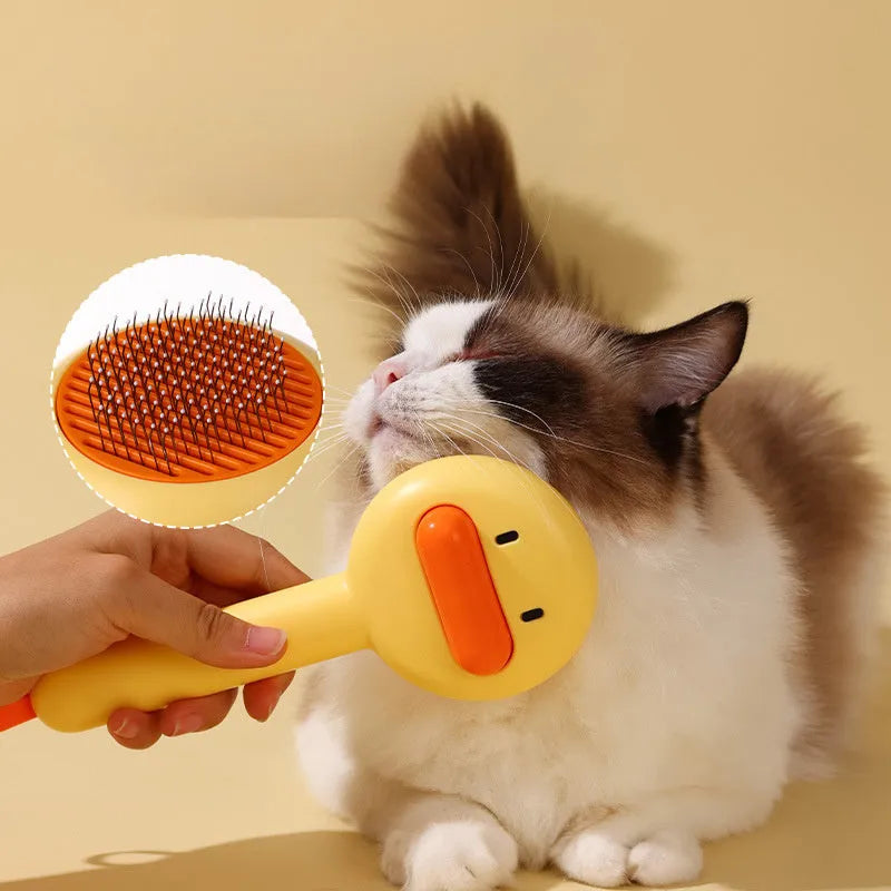 Small yellow duck-shaped pet comb with needle bristles for hair removal on cats and dogs.