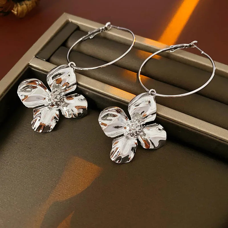 Flower and geometric design metal earrings in gold or silver electroplated finish with silver needle posts