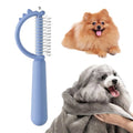 Blue dinosaur-shaped cat brush with stainless steel pins for self-cleaning grooming and dematting