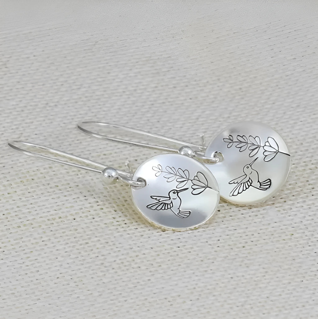 Silver glossy round women's earrings with bird and leaf motif