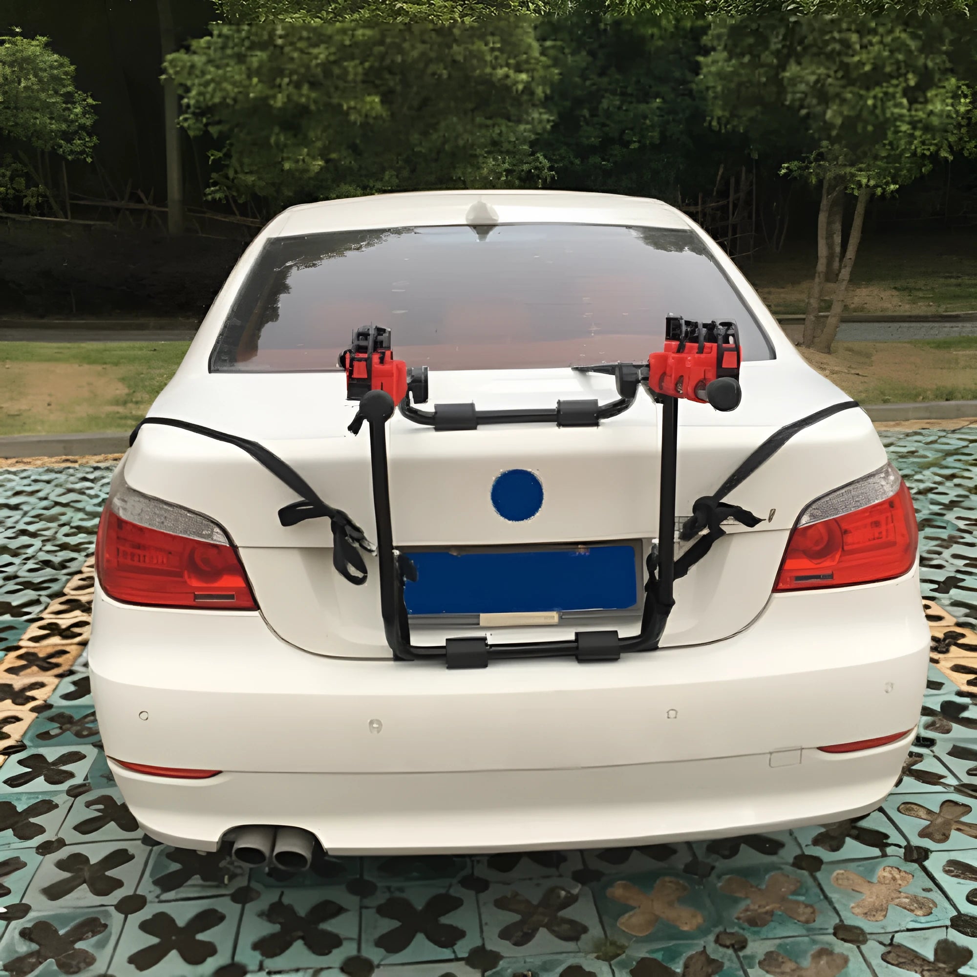 Black and red trunk-mounted car bike holder rack showing tie rope and pull belt fastening options