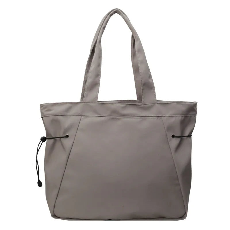 Oxford cloth folding shoulder tote bag in a choice of five colours including black, brown, and purple.