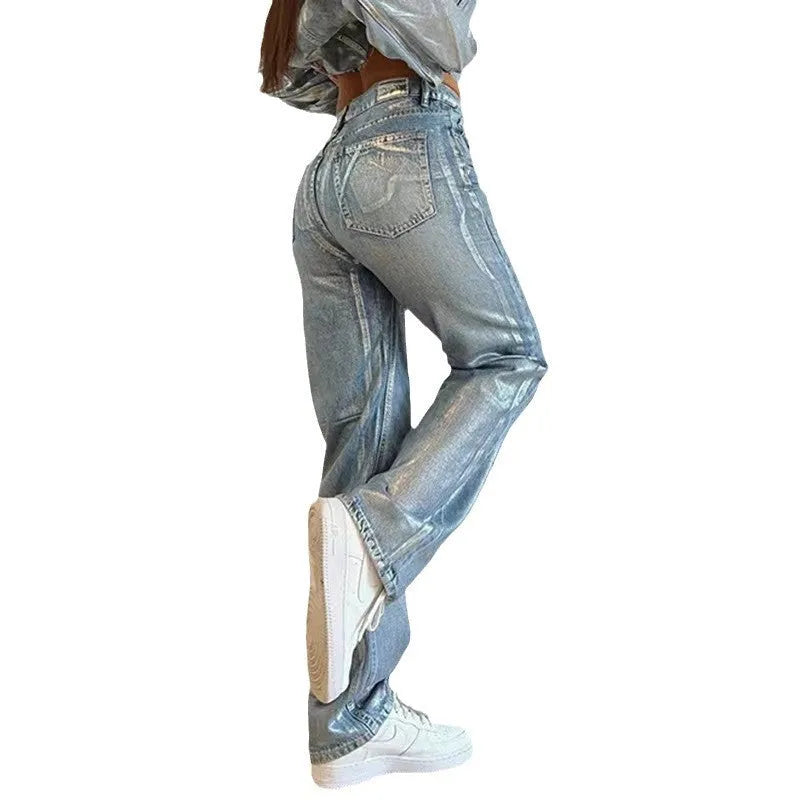 Blue high-waisted straight-leg jeans with washed denim finish on streetwear background