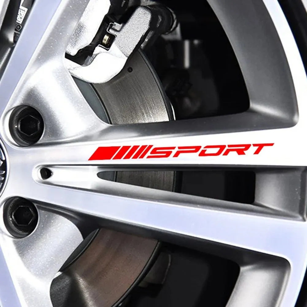Red hollow sports design car rim sticker on a silver alloy wheel.