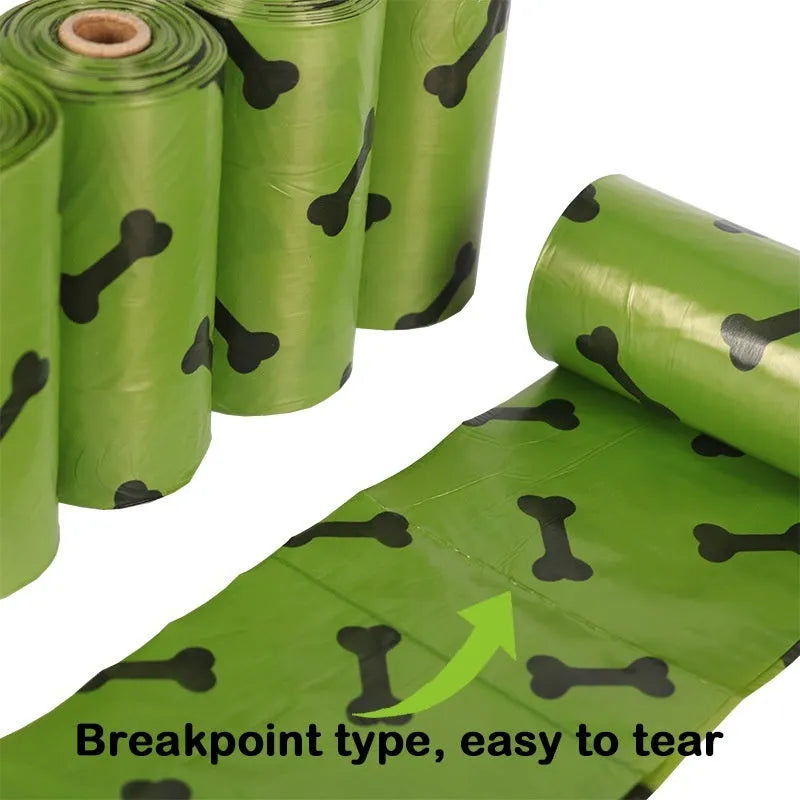 Roll of army green degradable dog poop bags with black bone print, showing bag size scale