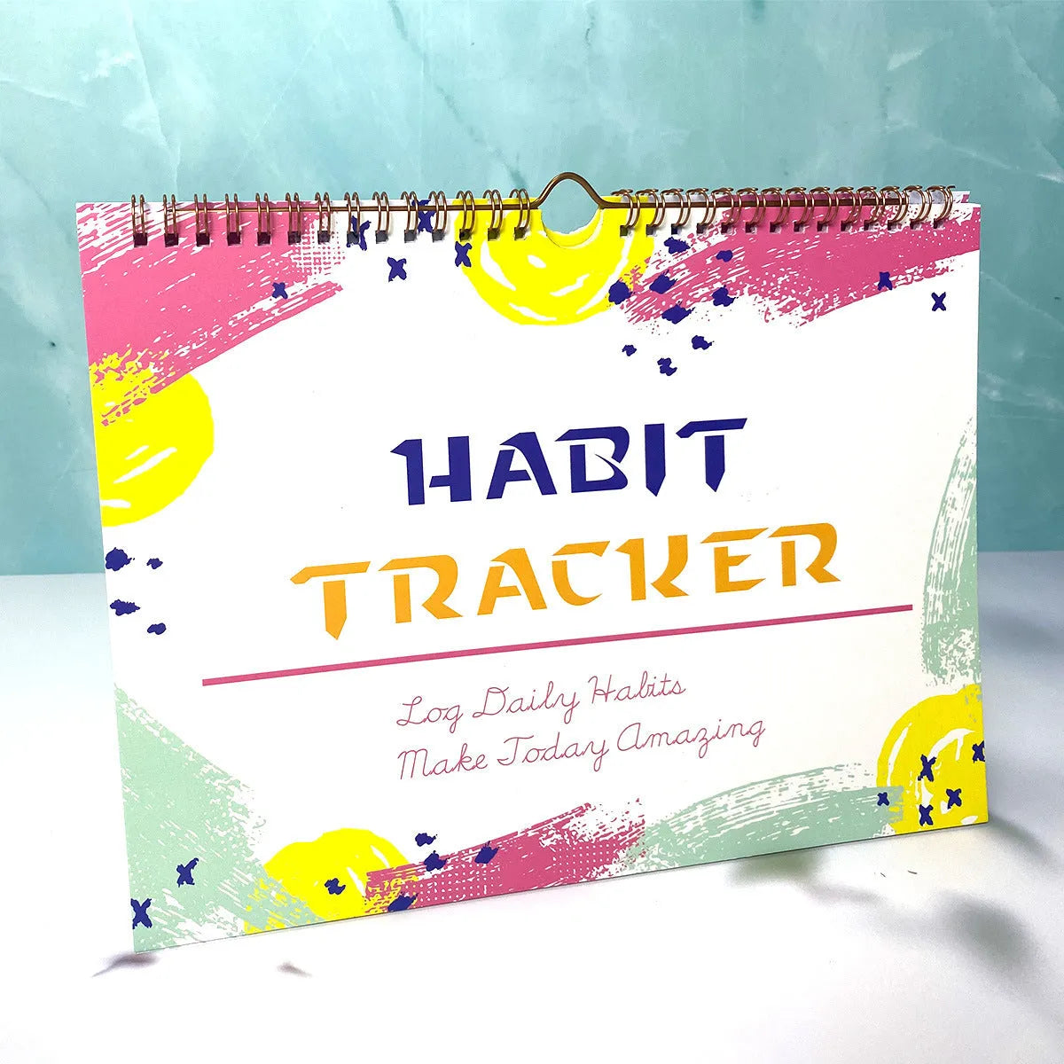 Habit tracking book with 12 pages showing colour options and 21x28cm size