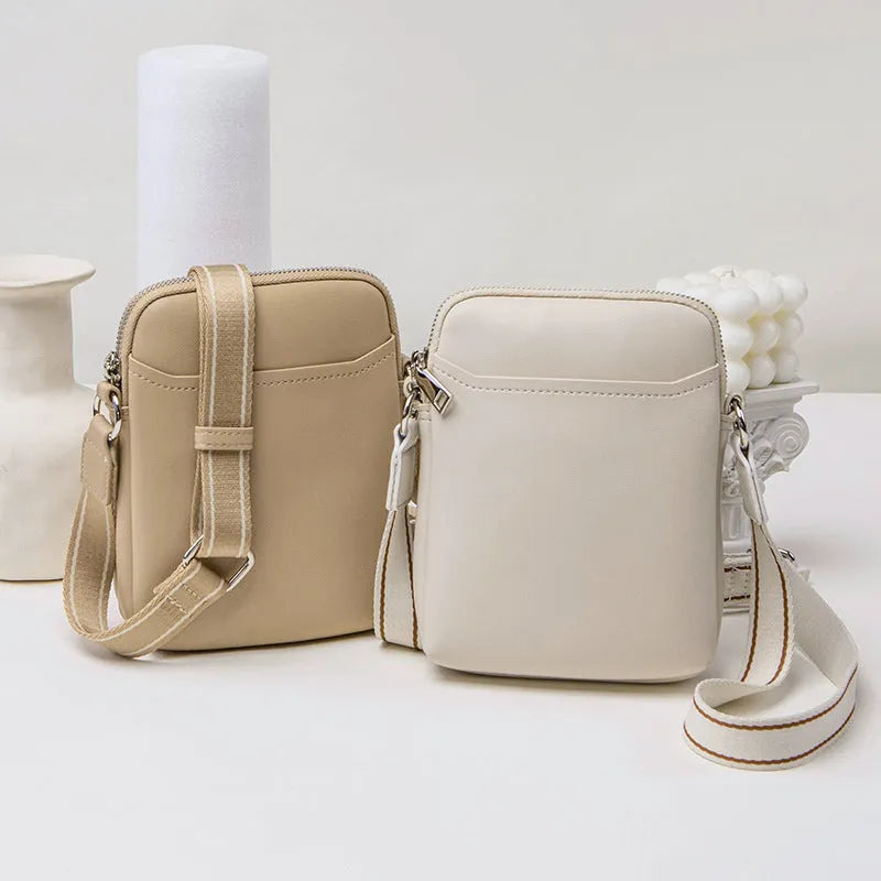 Black PU mobile phone bag with crossbody strap showing shoulder carry option
