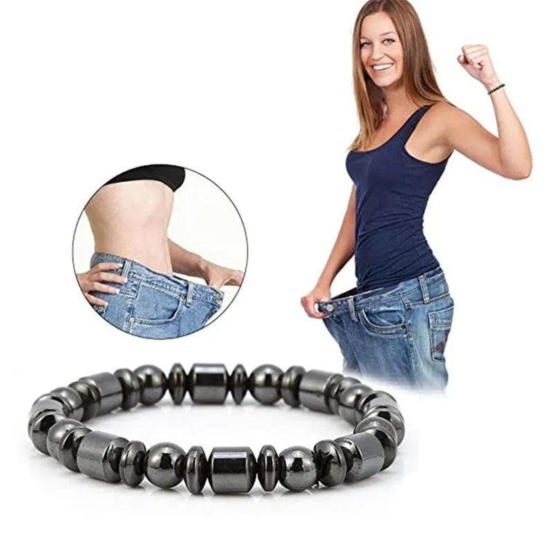 Black pentagram stone magnetic therapy bracelet with stretch fit on a wrist.