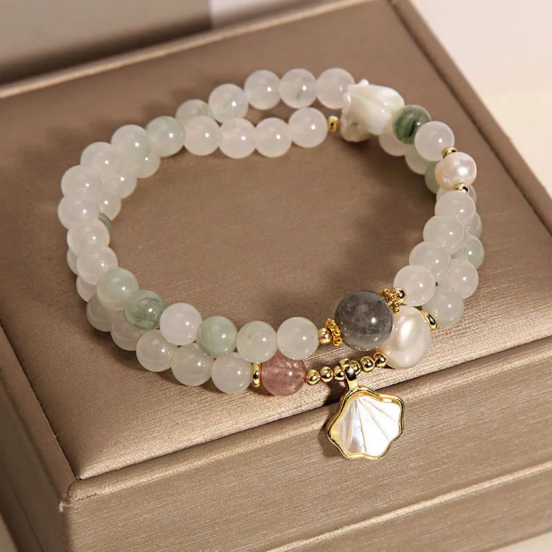 Women's crystal bracelet with a gold-plated ginkgo leaf pendant and rhinestone details.