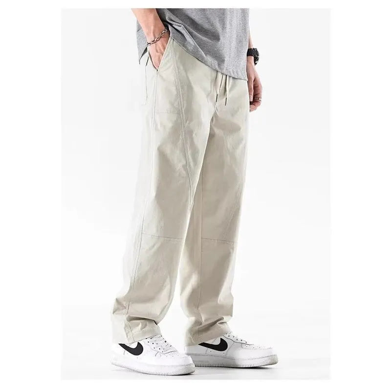 Women's milky white cotton wide-leg trousers with a straight pants-mouth opening, laid flat.