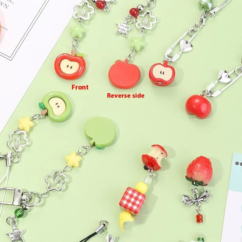 Coloured plastic fruit phone charms with rope attachments including apple and strawberry designs