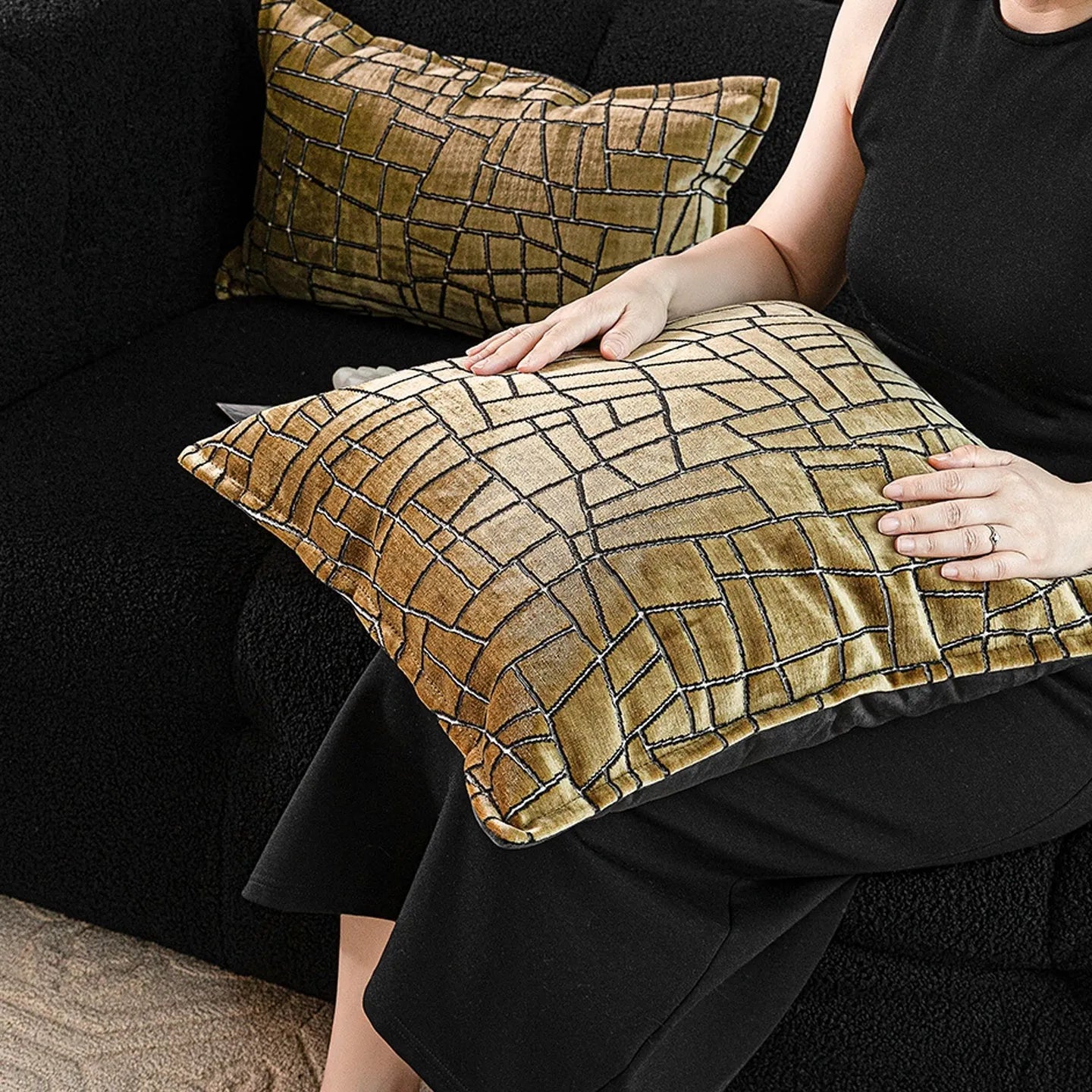 Gold geometric pattern polyester pillow cover shown in square and waist pillow sizes on a grey sofa.