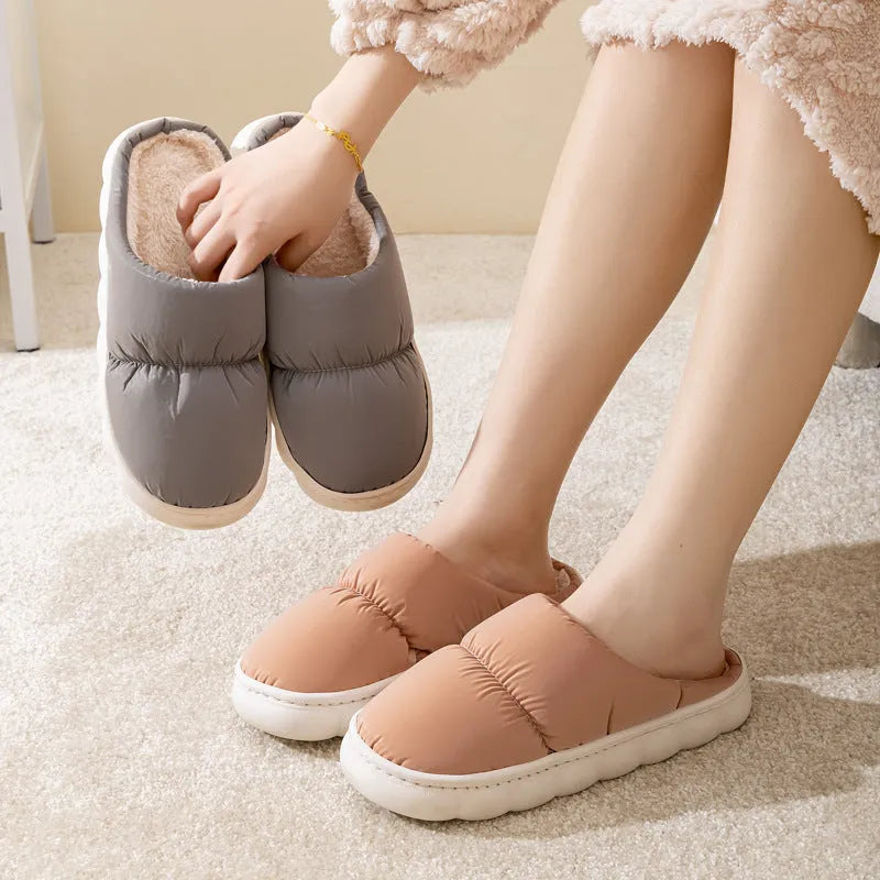 Blue winter slippers for indoor use with a thick rubber non-slip sole and artificial plush lining.