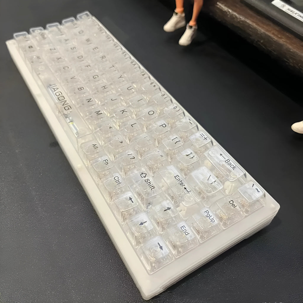 Universal transparent plastic 132-key mechanical keyboard key cap set laid out.