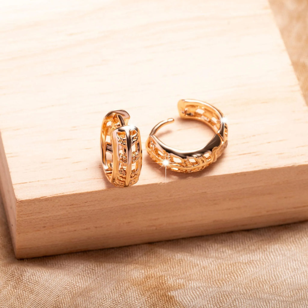 Rose gold finished leaf-shaped hollowed-out earrings with heart detail on copper base