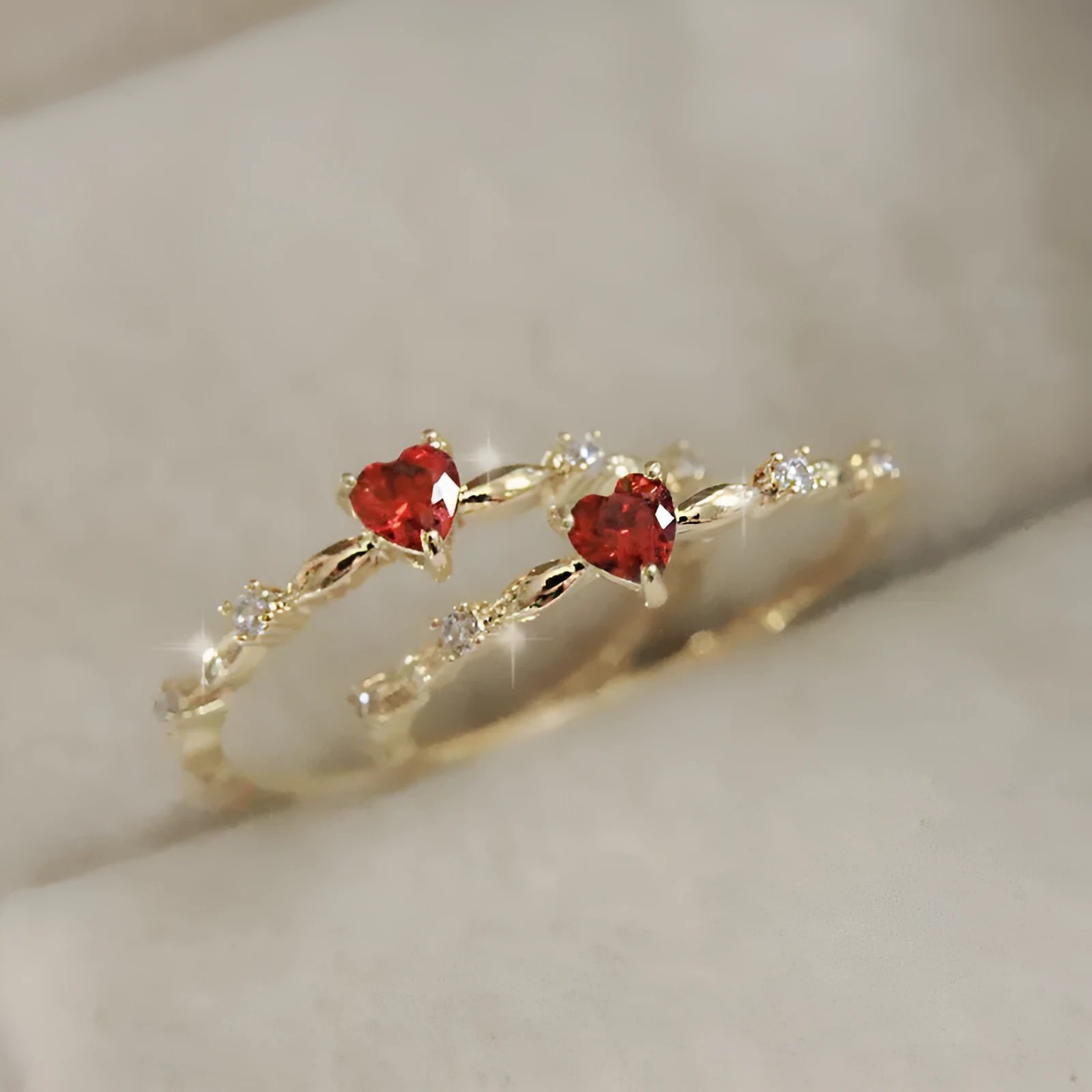Gold electroplated copper ring with a peach heart charm and set zircon stone.