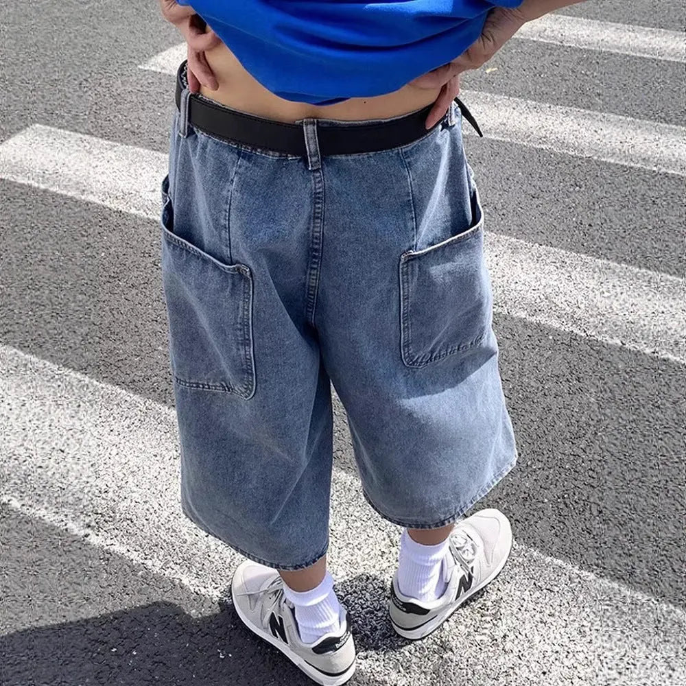 Blue men's washed denim pirate shorts with a high waist and cropped length on a neutral background.