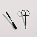 Black pet grooming brush with soft bristles and a comb for gentle eye cleaning on dogs and cats.