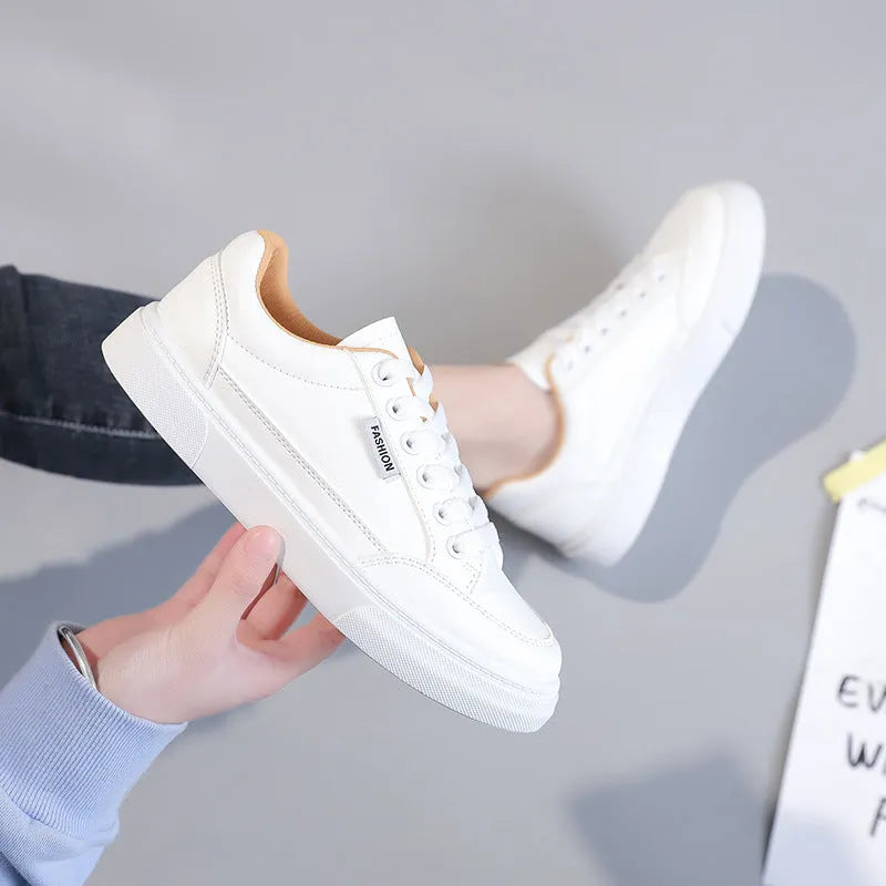 Korean style white low top PU sneakers for women on a plain background