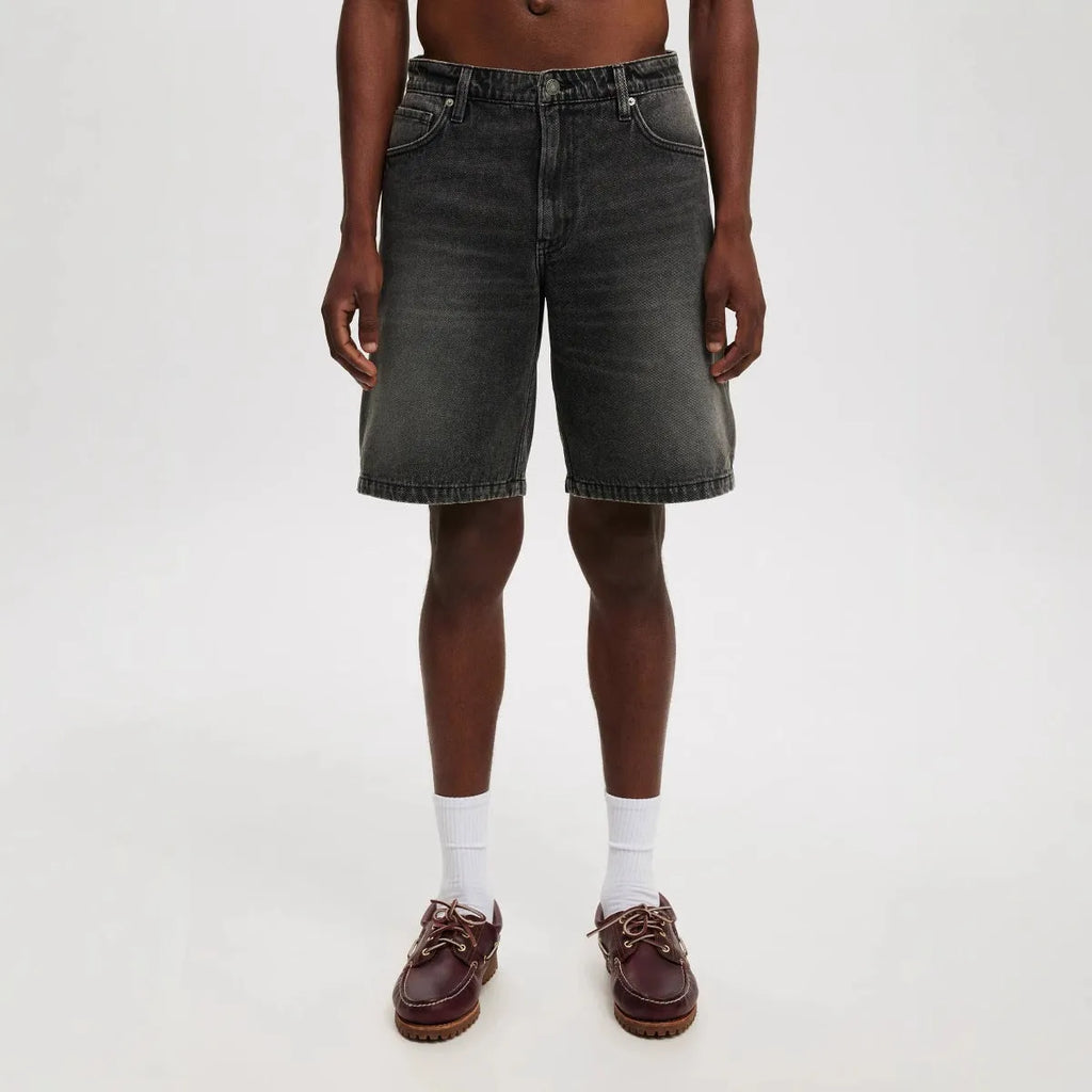 Men's loose straight-leg jeans in light blue, black, and grey denim with cotton composition