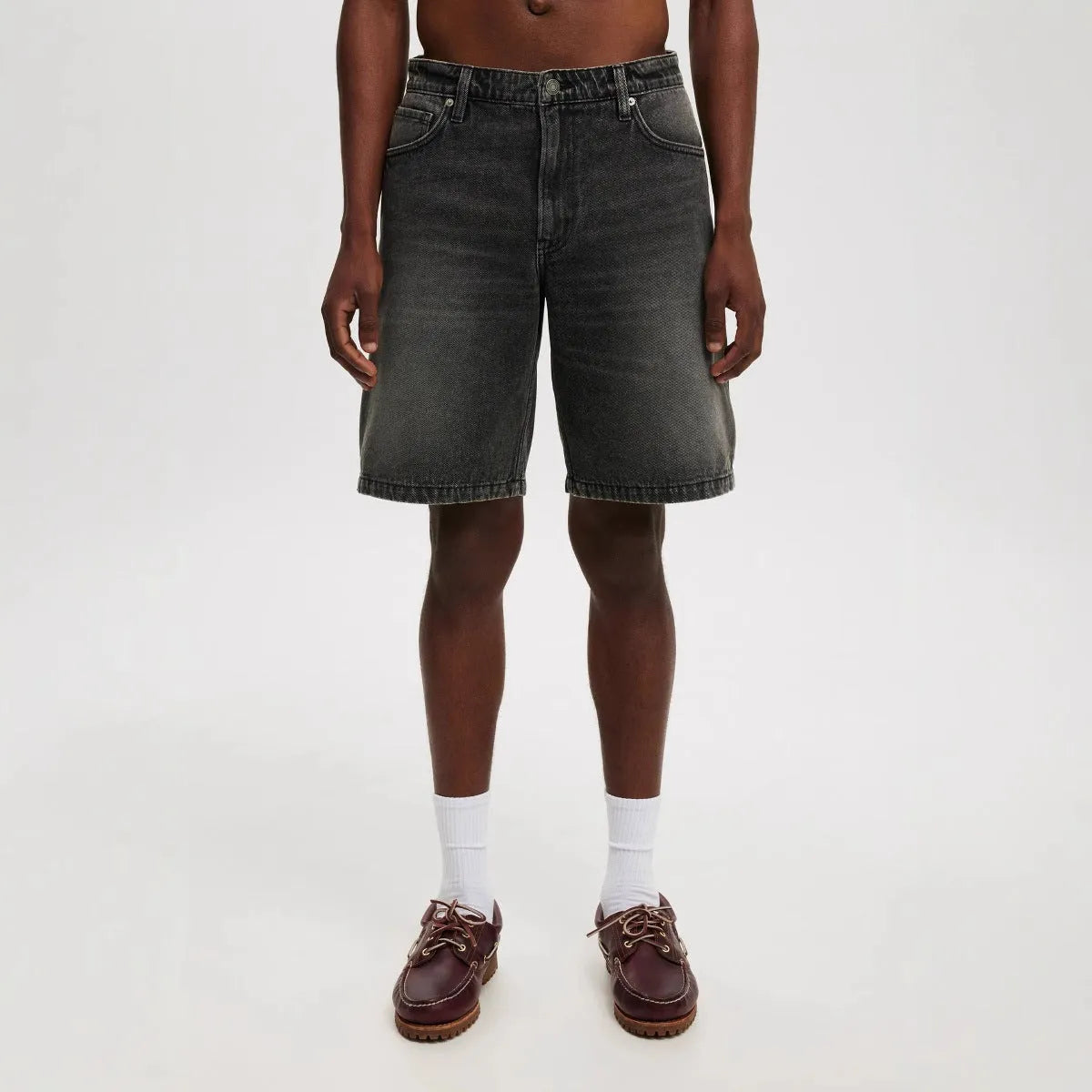 Men's loose straight-leg jeans in light blue, black, and grey denim with cotton composition