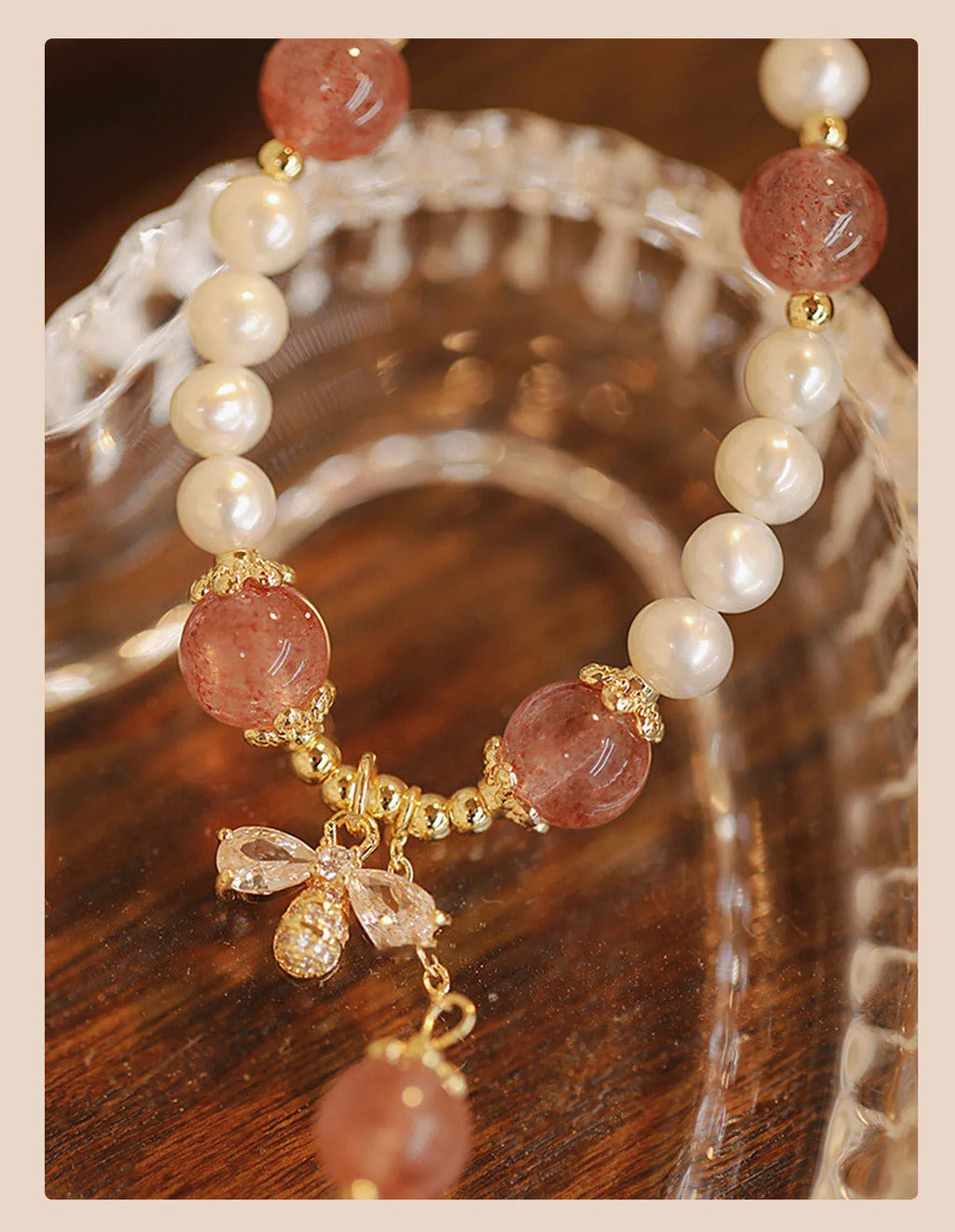 Women's handmade strawberry quartz crystal bracelet with stringed pearls and bow decoration