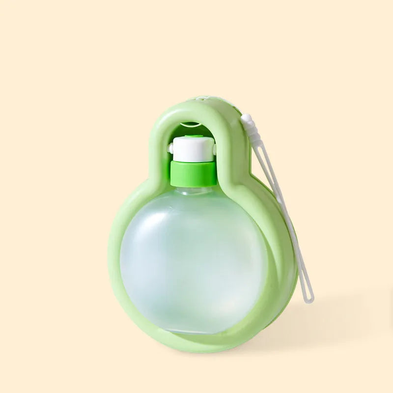 Green portable pet travel water bottle with pull-out drinking bowl for dogs