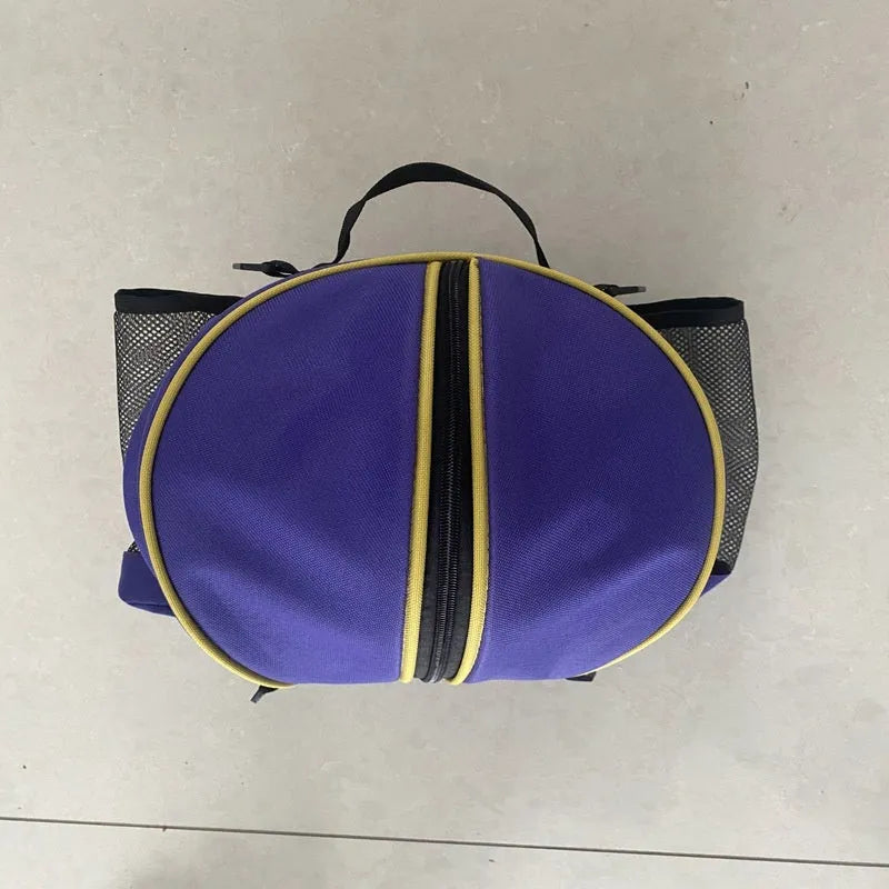 Black Oxford cloth basketball bag with one shoulder strap, shown next to a basketball.