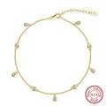 Silver women's anklet with a geometric pendant in a gold tone finish.