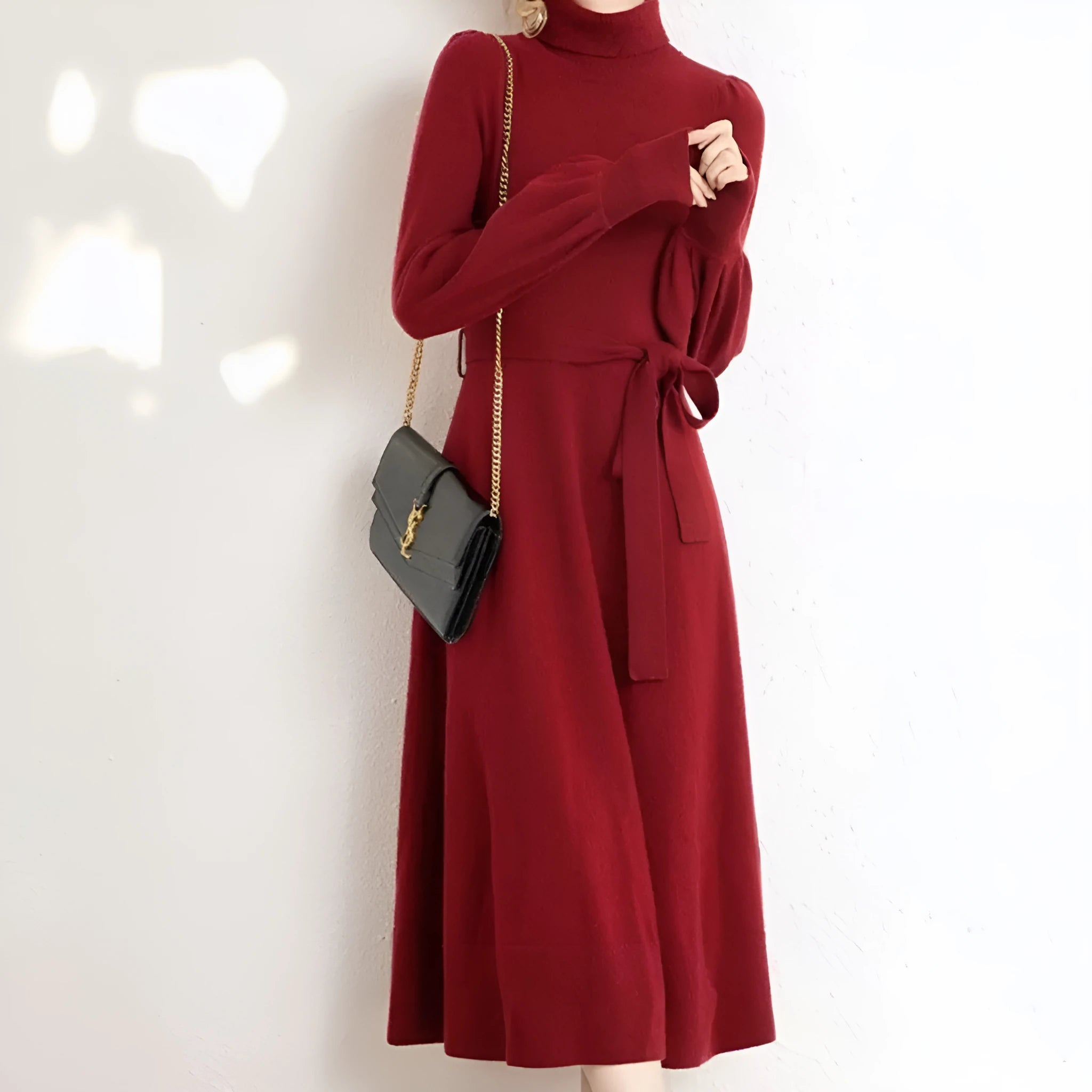 Loose turtleneck knit dress for women with long sleeves, elastic waist, and a big hem in a solid colour.