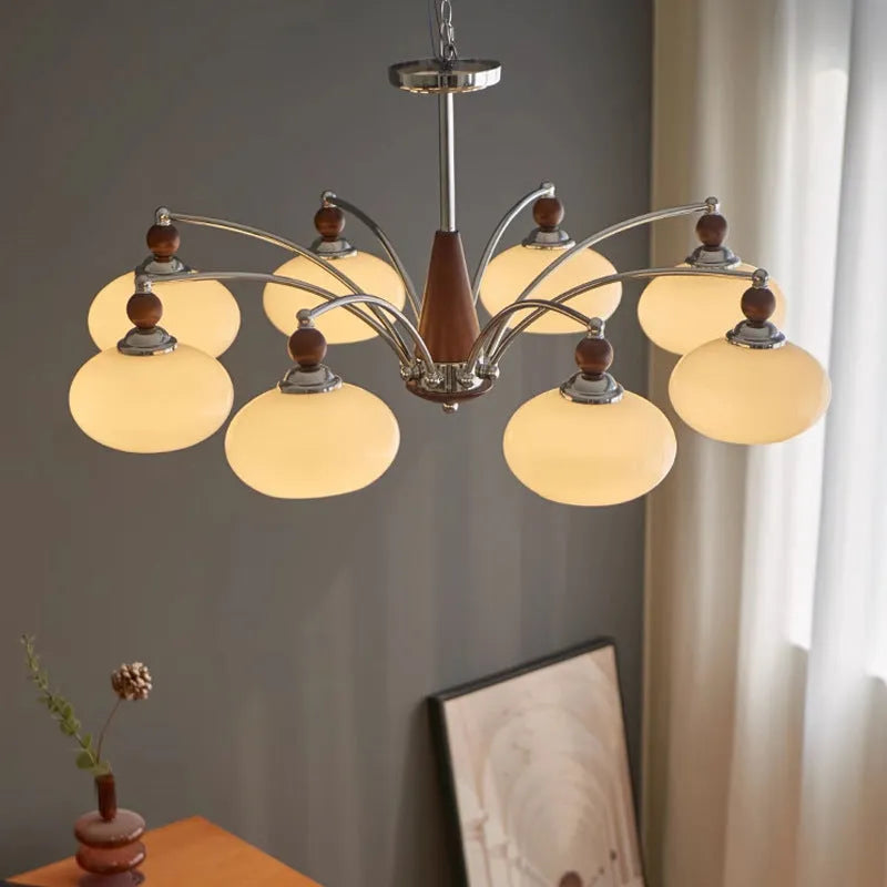 Middle Ancient style persimmon glass chandelier with chrome arms and milky white glass lampshades.