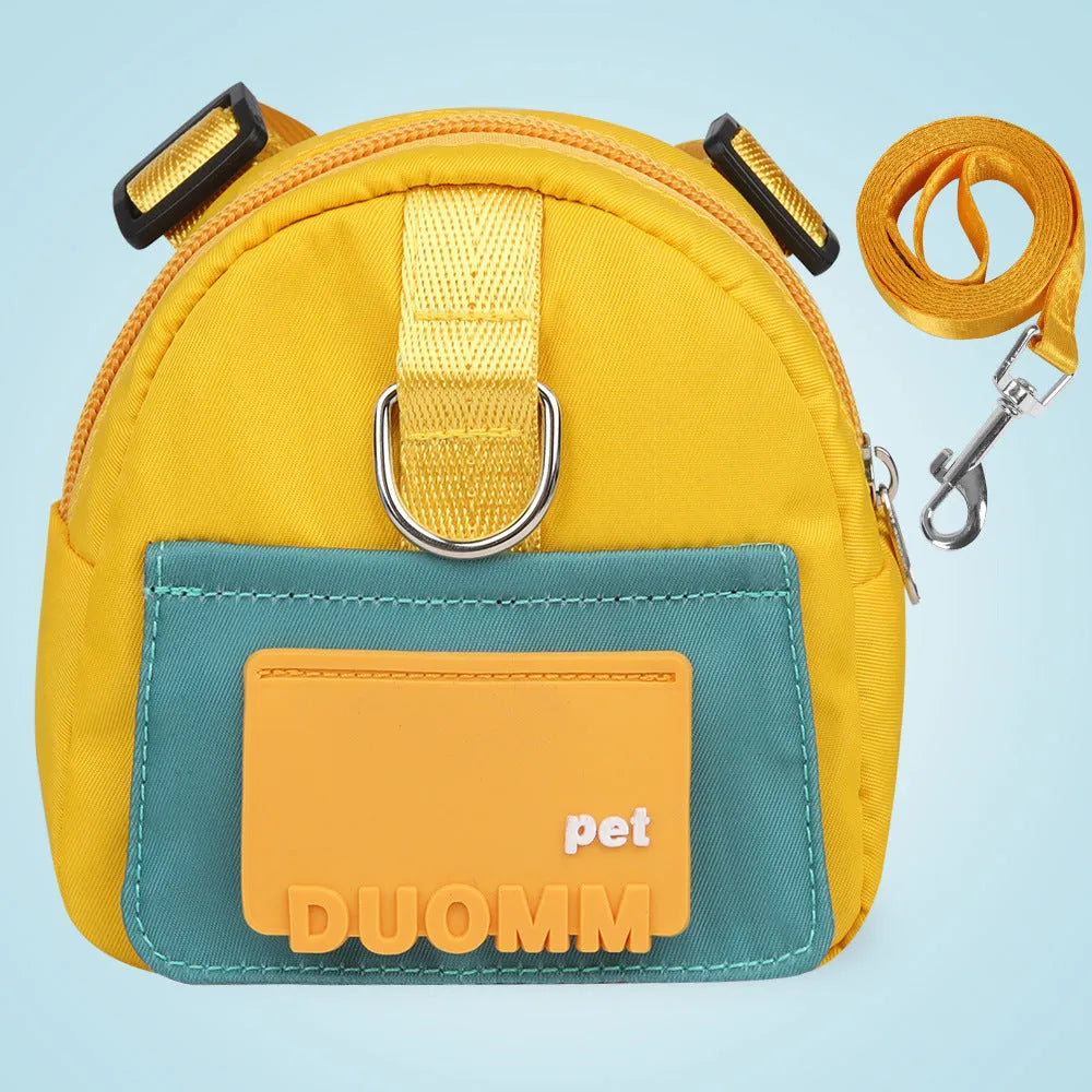 Blue adjustable dog backpack harness with storage pockets and a built-in tow rope laid flat.