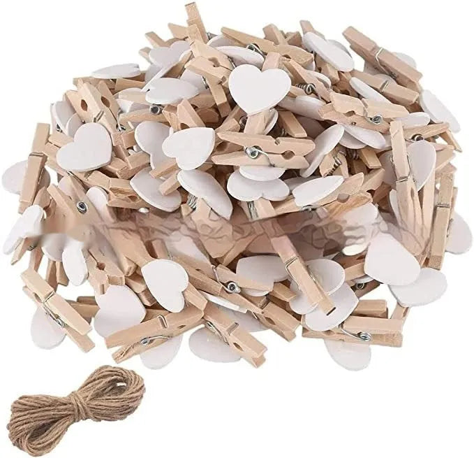 Set of five handmade solid wood heart-shaped clips in red, white, and rose red on a wooden surface.