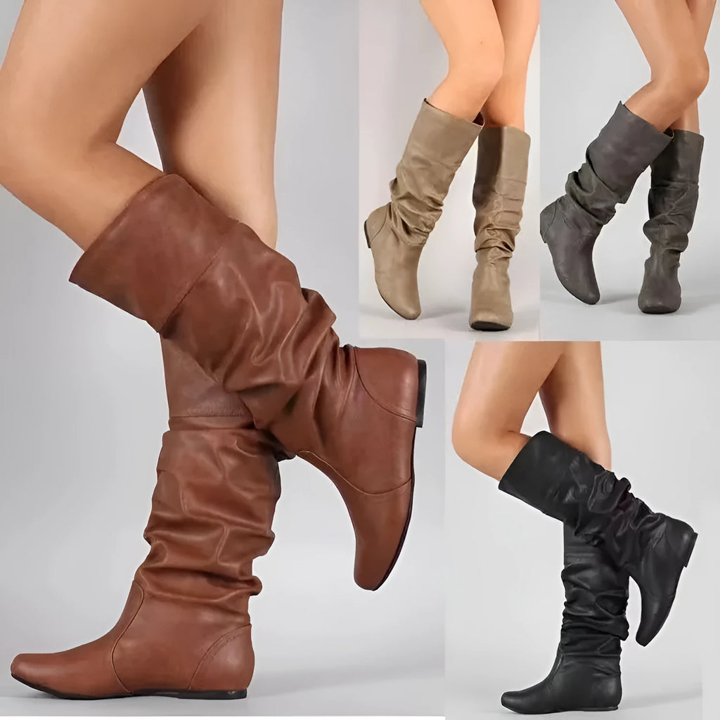 Women's flat ankle boots in black with a round toe, slip-on design, and high cylinder cut.