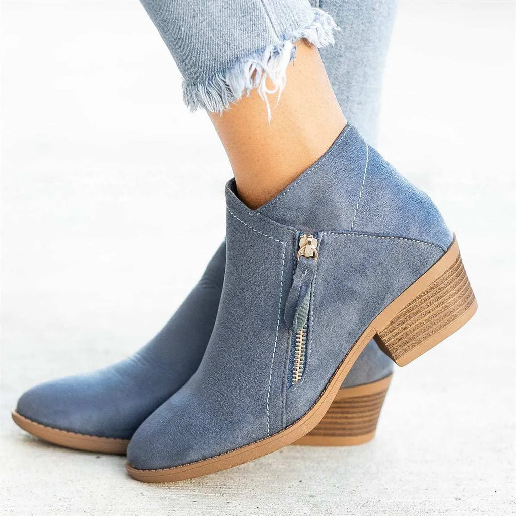 Women's ankle boots in suede with a side zip and chunky heel, shown in beige colour.