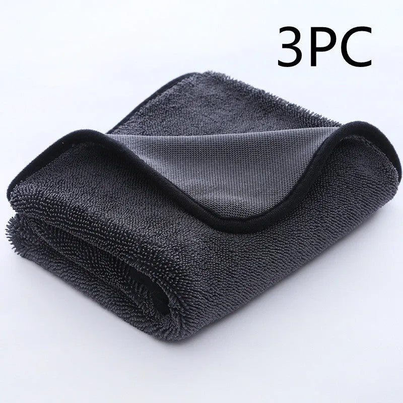 Grey automobile cleaning cloth with black edging showing spiral hair texture and hemmed edges