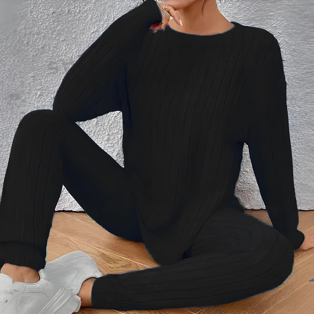 Black sunken stripe polyester two-piece loungewear set with top and pants.