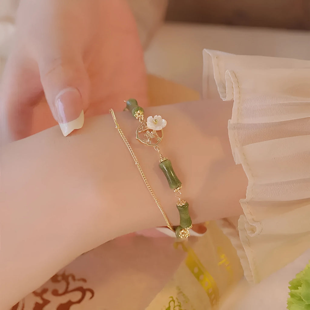 Handmade natural olivine women's bracelet with Chinese double layer twin bells and an olive branch design.