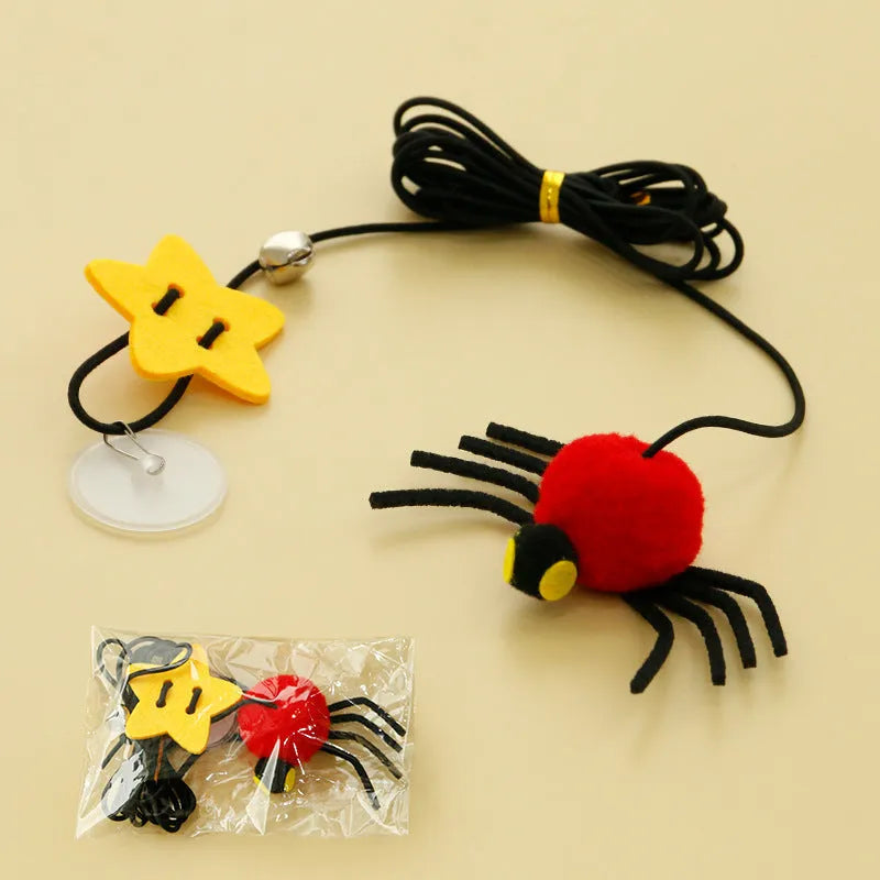 Hanging cat toy with red elastic rope, feather, and bell spider attachment mounted on door