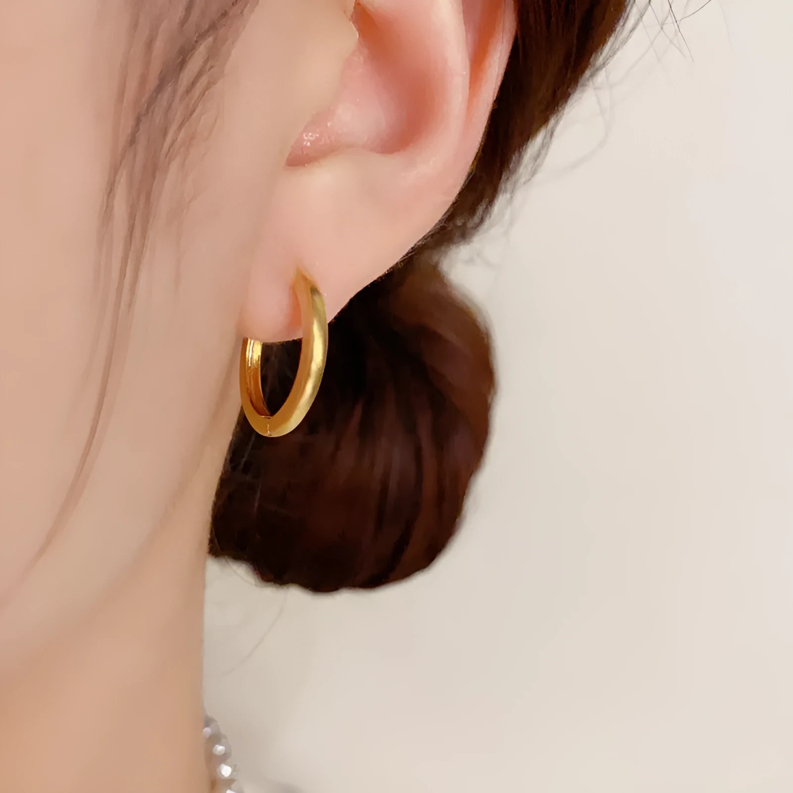Gold and silver geometric round ear clip earrings for women on a simple background.