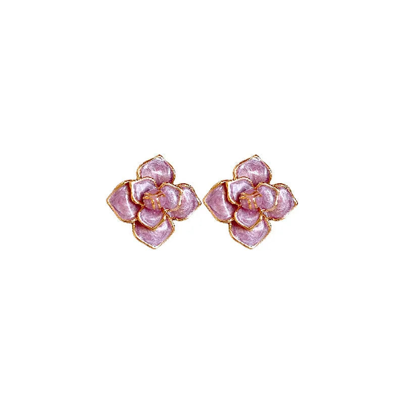Close-up of gold plated purple oil-spot glaze flower stud earrings on copper base with needle post