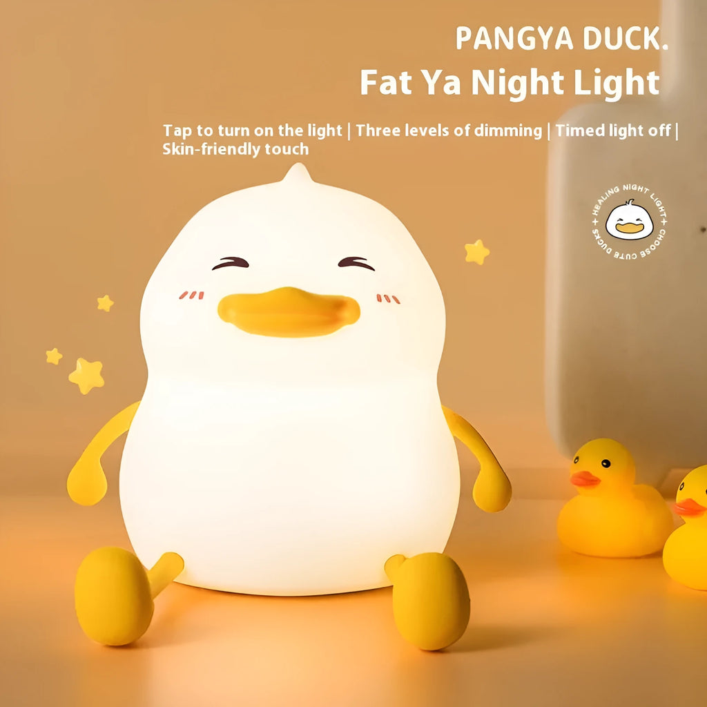 Chubby white USB rechargeable LED night light with built-in silicone phone holder on its base.