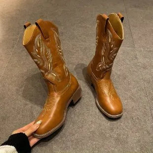 Brown women's mid-calf Martin boots with embroidered detail on the upper and a low square heel.