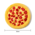 Yellow pizza slice shaped plush squeaky dog chew toy on a white background