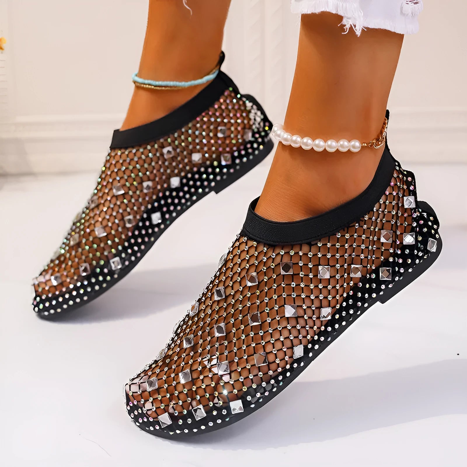 Women's flat sandals with mesh upper, colourful rhinestone detail, and a round toe.