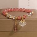 Women's strawberry quartz and white agate crystal bracelet with auspicious cloud charms