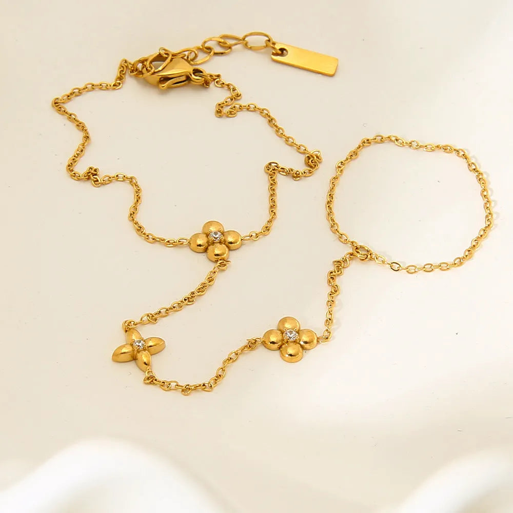 Gold stainless steel women's bracelet with eight-pointed stars and floral geometric design