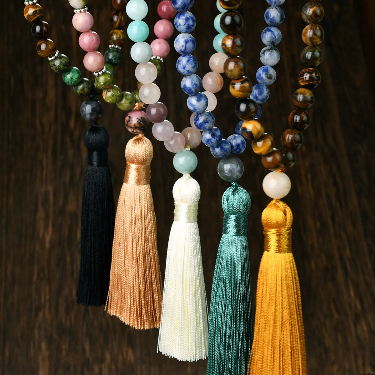 Long bohemian necklace with 108 stone tassels and a geometric gemstone pendant on an 81cm chain.