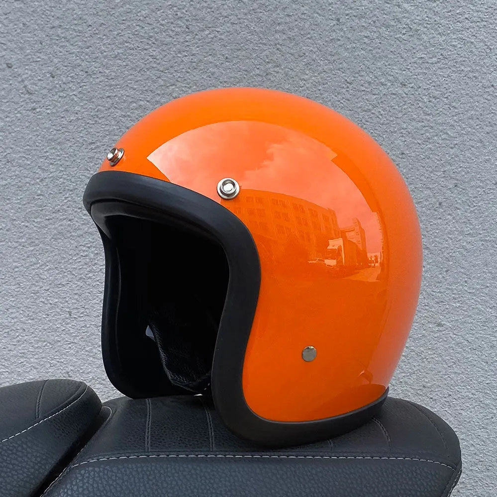 Cement grey retro half motorcycle helmet with glass fibre shell on a plain background.