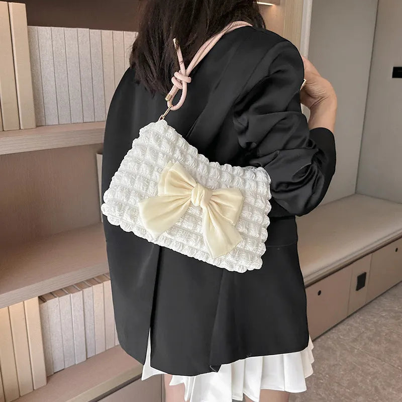 Women's black canvas one-shoulder handbag with a horizontal square shape and single strap